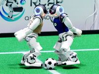 Robots play soccer at the 2024 Asia Pacific Robot World Cup Qingdao International Invitational in a football match in Qingdao, China, on Oct...