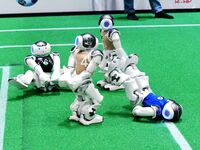 Robots play soccer at the 2024 Asia Pacific Robot World Cup Qingdao International Invitational in a football match in Qingdao, China, on Oct...