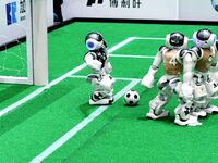 Robots play soccer at the 2024 Asia Pacific Robot World Cup Qingdao International Invitational in a football match in Qingdao, China, on Oct...