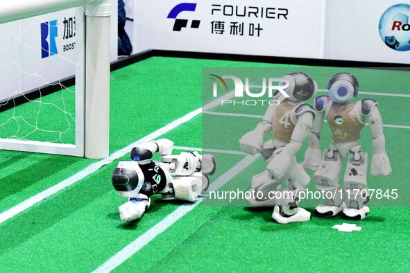 Robots play soccer at the 2024 Asia Pacific Robot World Cup Qingdao International Invitational in a football match in Qingdao, China, on Oct...