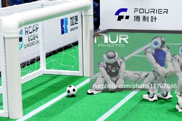 Robots play soccer at the 2024 Asia Pacific Robot World Cup Qingdao International Invitational in a football match in Qingdao, China, on Oct...