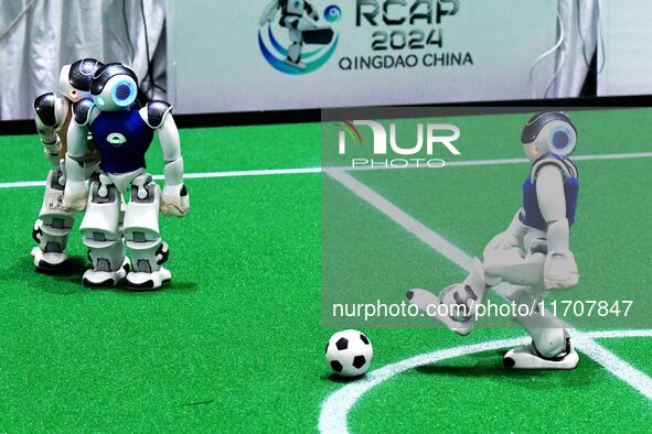 Robots play soccer at the 2024 Asia Pacific Robot World Cup Qingdao International Invitational in a football match in Qingdao, China, on Oct...