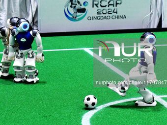 Robots play soccer at the 2024 Asia Pacific Robot World Cup Qingdao International Invitational in a football match in Qingdao, China, on Oct...