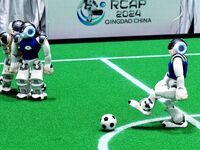 Robots play soccer at the 2024 Asia Pacific Robot World Cup Qingdao International Invitational in a football match in Qingdao, China, on Oct...