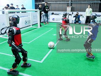 Robots play soccer at the 2024 Asia Pacific Robot World Cup Qingdao International Invitational in a football match in Qingdao, China, on Oct...