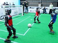 Robots play soccer at the 2024 Asia Pacific Robot World Cup Qingdao International Invitational in a football match in Qingdao, China, on Oct...