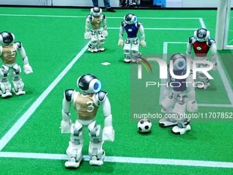 Robots play soccer at the 2024 Asia Pacific Robot World Cup Qingdao International Invitational in a football match in Qingdao, China, on Oct...