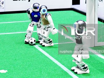 Robots play soccer at the 2024 Asia Pacific Robot World Cup Qingdao International Invitational in a football match in Qingdao, China, on Oct...