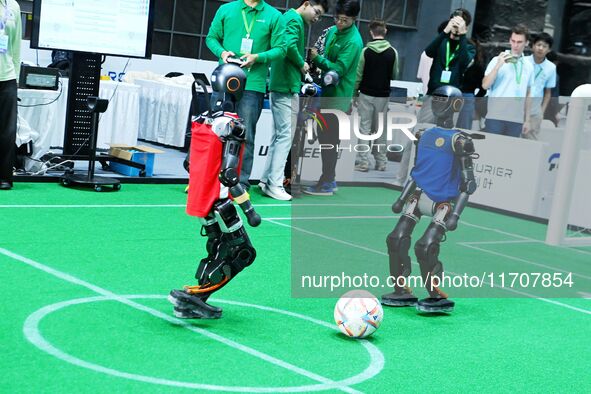 Robots play soccer at the 2024 Asia Pacific Robot World Cup Qingdao International Invitational in a football match in Qingdao, China, on Oct...