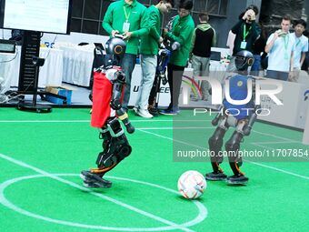 Robots play soccer at the 2024 Asia Pacific Robot World Cup Qingdao International Invitational in a football match in Qingdao, China, on Oct...