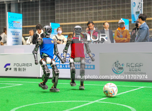 A robot plays in a soccer match at the Qingdao International Invitational Tournament of the 2024 Asia-Pacific RoboCup in Qingdao, China, on...