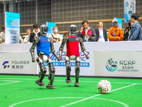 A robot plays in a soccer match at the Qingdao International Invitational Tournament of the 2024 Asia-Pacific RoboCup in Qingdao, China, on...