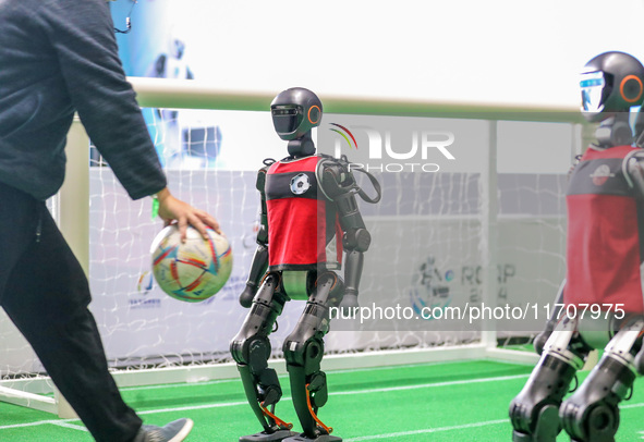 A robot plays in a soccer match at the Qingdao International Invitational Tournament of the 2024 Asia-Pacific RoboCup in Qingdao, China, on...