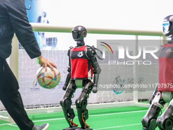 A robot plays in a soccer match at the Qingdao International Invitational Tournament of the 2024 Asia-Pacific RoboCup in Qingdao, China, on...