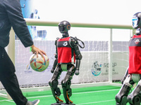 A robot plays in a soccer match at the Qingdao International Invitational Tournament of the 2024 Asia-Pacific RoboCup in Qingdao, China, on...