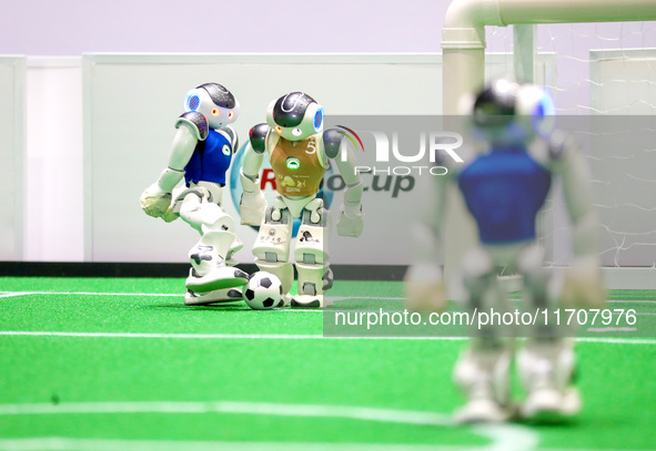 A robot plays in a soccer match at the Qingdao International Invitational Tournament of the 2024 Asia-Pacific RoboCup in Qingdao, China, on...