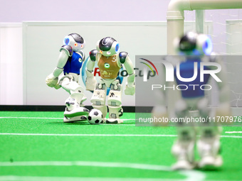 A robot plays in a soccer match at the Qingdao International Invitational Tournament of the 2024 Asia-Pacific RoboCup in Qingdao, China, on...