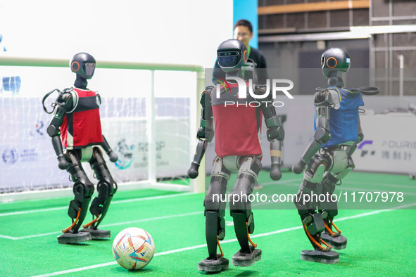 A robot plays in a soccer match at the Qingdao International Invitational Tournament of the 2024 Asia-Pacific RoboCup in Qingdao, China, on...