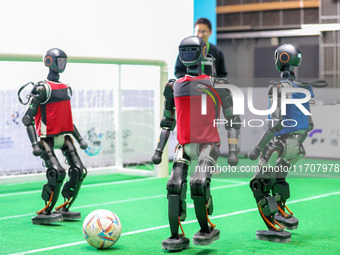 A robot plays in a soccer match at the Qingdao International Invitational Tournament of the 2024 Asia-Pacific RoboCup in Qingdao, China, on...