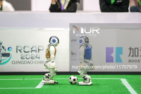 A robot plays in a soccer match at the Qingdao International Invitational Tournament of the 2024 Asia-Pacific RoboCup in Qingdao, China, on...