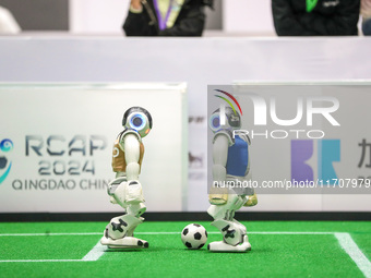 A robot plays in a soccer match at the Qingdao International Invitational Tournament of the 2024 Asia-Pacific RoboCup in Qingdao, China, on...