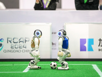 A robot plays in a soccer match at the Qingdao International Invitational Tournament of the 2024 Asia-Pacific RoboCup in Qingdao, China, on...