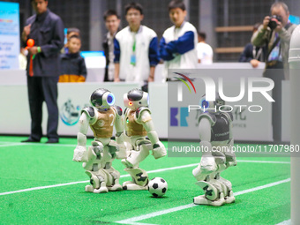 A robot plays in a soccer match at the Qingdao International Invitational Tournament of the 2024 Asia-Pacific RoboCup in Qingdao, China, on...