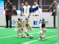 A robot plays in a soccer match at the Qingdao International Invitational Tournament of the 2024 Asia-Pacific RoboCup in Qingdao, China, on...