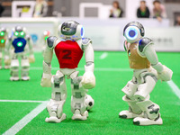 A robot plays in a soccer match at the Qingdao International Invitational Tournament of the 2024 Asia-Pacific RoboCup in Qingdao, China, on...