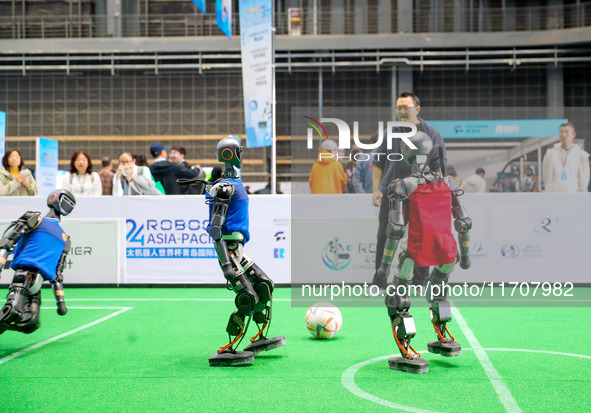 A robot plays in a soccer match at the Qingdao International Invitational Tournament of the 2024 Asia-Pacific RoboCup in Qingdao, China, on...