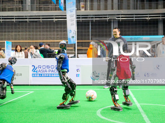 A robot plays in a soccer match at the Qingdao International Invitational Tournament of the 2024 Asia-Pacific RoboCup in Qingdao, China, on...