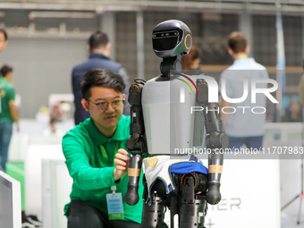 A player tests a robot during the Qingdao International Invitational Tournament of the 2024 Asia-Pacific RoboCup in Qingdao, China, on Octob...