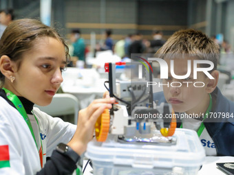 Two foreign players test a robot during the Qingdao International Invitational Tournament of the 2024 Asia-Pacific RoboCup in Qingdao, China...