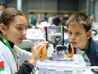 Two foreign players test a robot during the Qingdao International Invitational Tournament of the 2024 Asia-Pacific RoboCup in Qingdao, China...