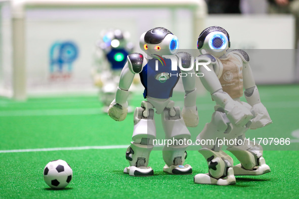 A robot plays in a soccer match at the Qingdao International Invitational Tournament of the 2024 Asia-Pacific RoboCup in Qingdao, China, on...