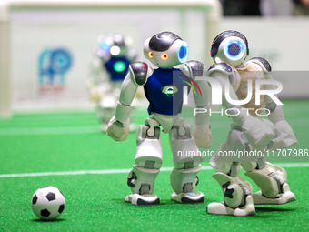 A robot plays in a soccer match at the Qingdao International Invitational Tournament of the 2024 Asia-Pacific RoboCup in Qingdao, China, on...