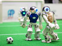 A robot plays in a soccer match at the Qingdao International Invitational Tournament of the 2024 Asia-Pacific RoboCup in Qingdao, China, on...