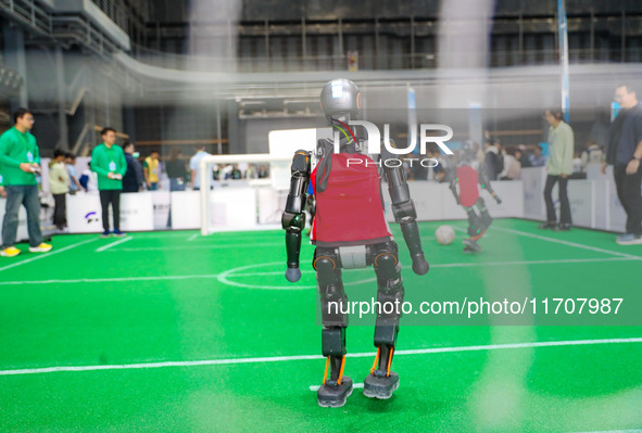 A robot plays in a soccer match at the Qingdao International Invitational Tournament of the 2024 Asia-Pacific RoboCup in Qingdao, China, on...