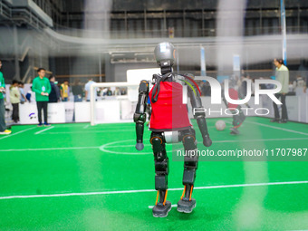 A robot plays in a soccer match at the Qingdao International Invitational Tournament of the 2024 Asia-Pacific RoboCup in Qingdao, China, on...