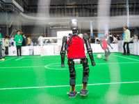 A robot plays in a soccer match at the Qingdao International Invitational Tournament of the 2024 Asia-Pacific RoboCup in Qingdao, China, on...