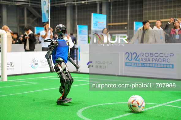 A robot plays in a soccer match at the Qingdao International Invitational Tournament of the 2024 Asia-Pacific RoboCup in Qingdao, China, on...