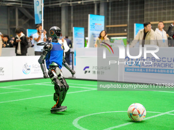 A robot plays in a soccer match at the Qingdao International Invitational Tournament of the 2024 Asia-Pacific RoboCup in Qingdao, China, on...