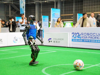 A robot plays in a soccer match at the Qingdao International Invitational Tournament of the 2024 Asia-Pacific RoboCup in Qingdao, China, on...