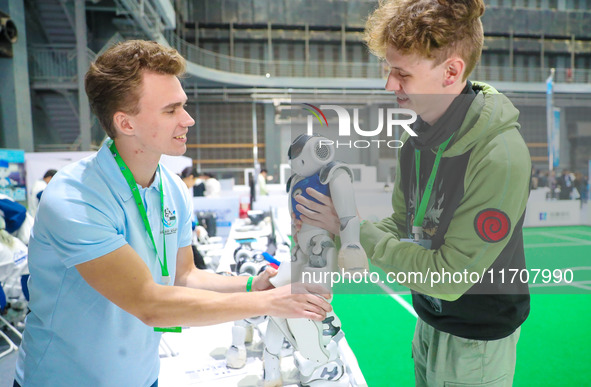 Two foreign players test a robot during the Qingdao International Invitational Tournament of the 2024 Asia-Pacific RoboCup in Qingdao, China...