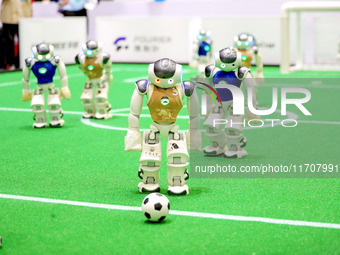 A robot plays in a soccer match at the Qingdao International Invitational Tournament of the 2024 Asia-Pacific RoboCup in Qingdao, China, on...