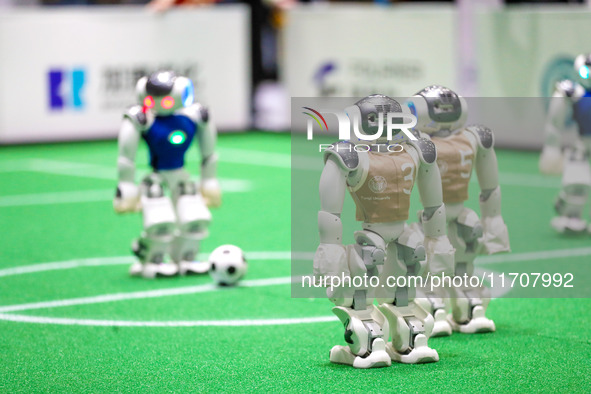 A robot plays in a soccer match at the Qingdao International Invitational Tournament of the 2024 Asia-Pacific RoboCup in Qingdao, China, on...