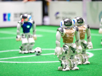 A robot plays in a soccer match at the Qingdao International Invitational Tournament of the 2024 Asia-Pacific RoboCup in Qingdao, China, on...