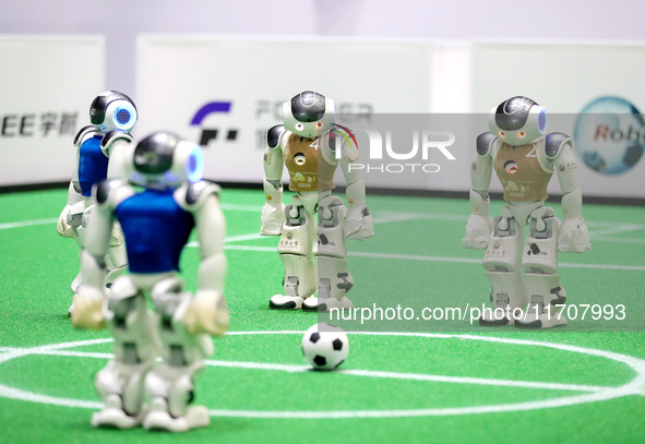 A robot plays in a soccer match at the Qingdao International Invitational Tournament of the 2024 Asia-Pacific RoboCup in Qingdao, China, on...