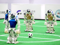 A robot plays in a soccer match at the Qingdao International Invitational Tournament of the 2024 Asia-Pacific RoboCup in Qingdao, China, on...