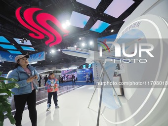 Visitors view the ''C919 passenger jet model'' at the second CATA Aviation Conference in Beijing, China, on October 26, 2024. (